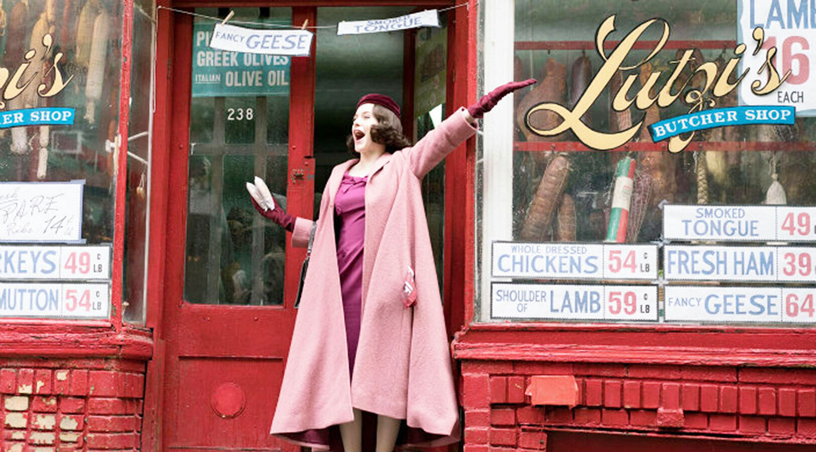 An image of Midge Maisel standing in the entryway of Lutzi's butcher shop in a scene from the marvelous mrs. maisel