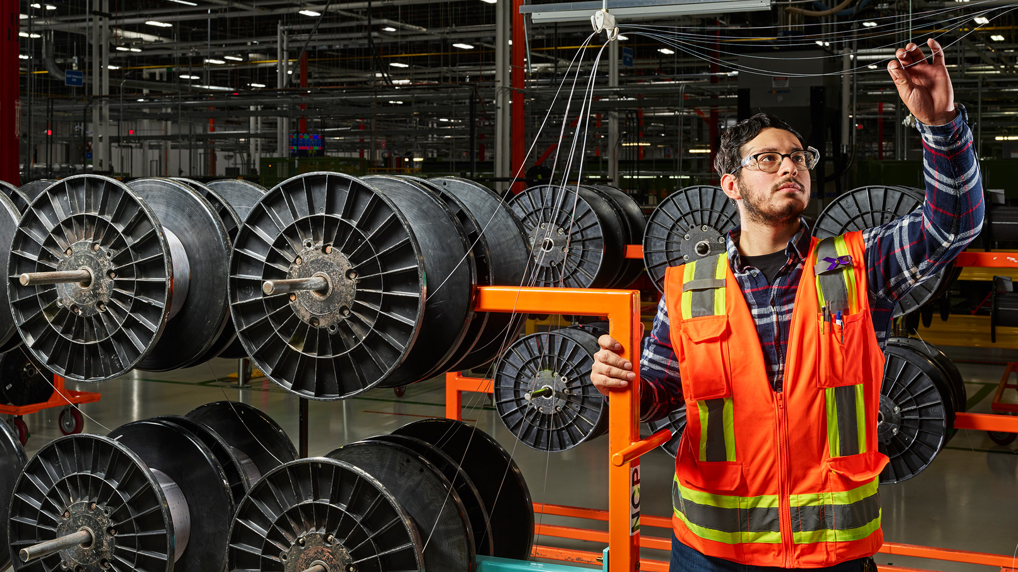 Technician inspecting fiber optic cables.