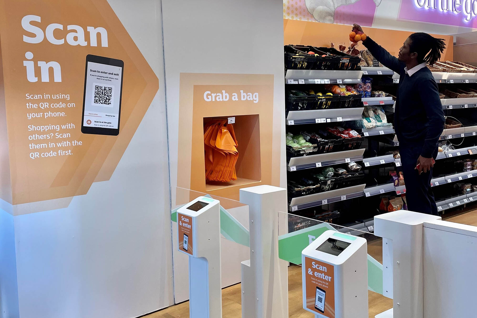 A man enters and shops at the new Sainsbury's location at Holborn Circus, using Amazon's Just Walk Out technology.