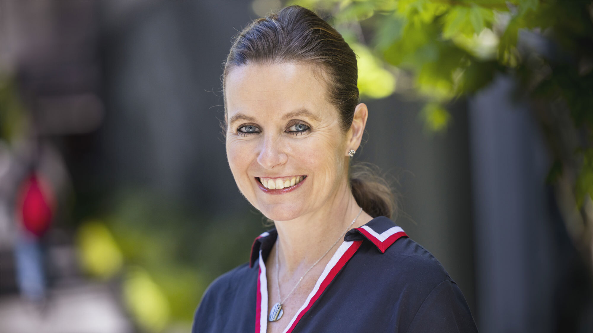 A headshot of Claire Peters standing outside.