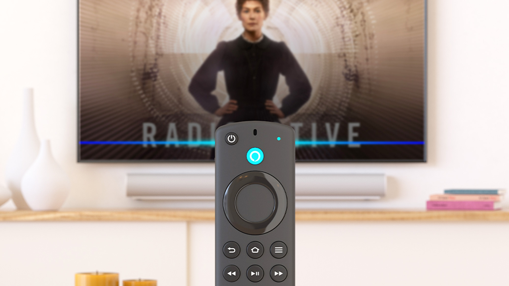 Fire TV Stick remote in front of a TV.