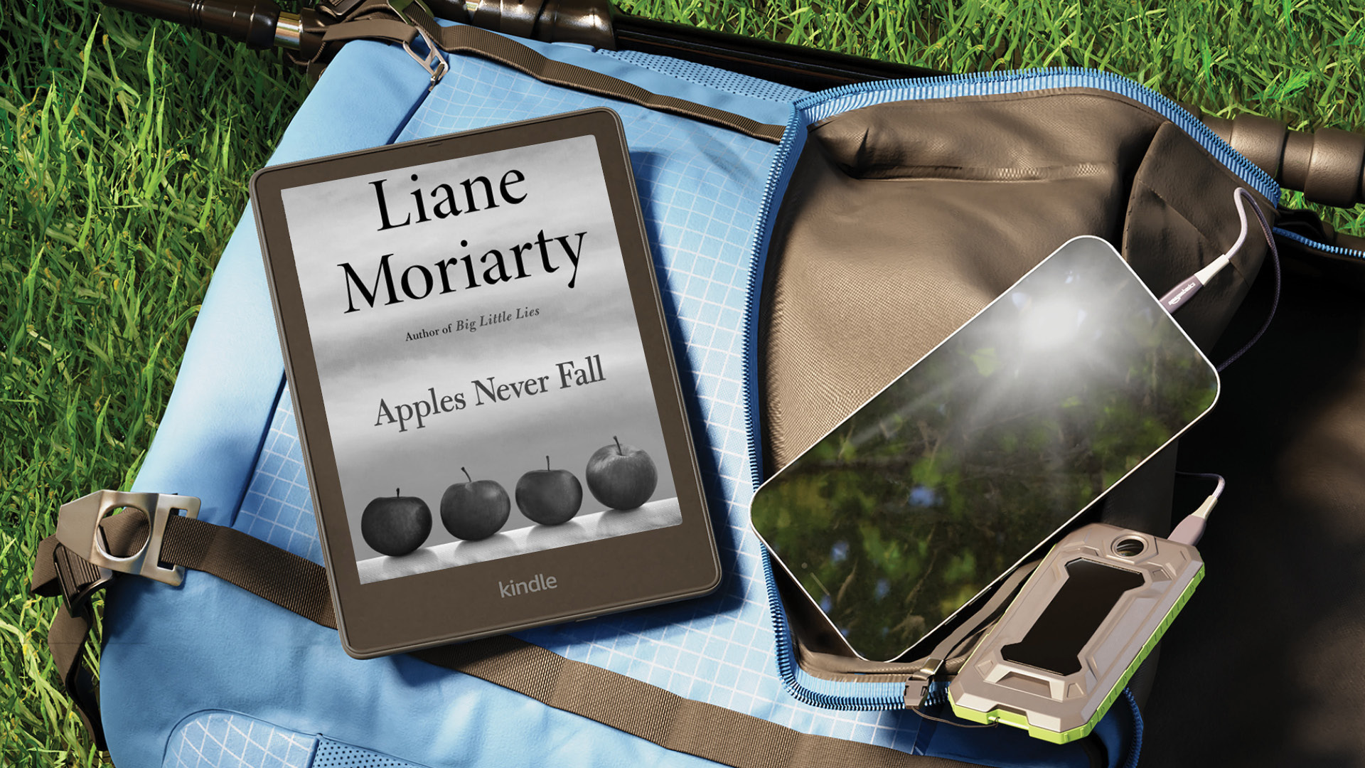 A Kindle open to "Apples Never Fall" by Liane Moriarty