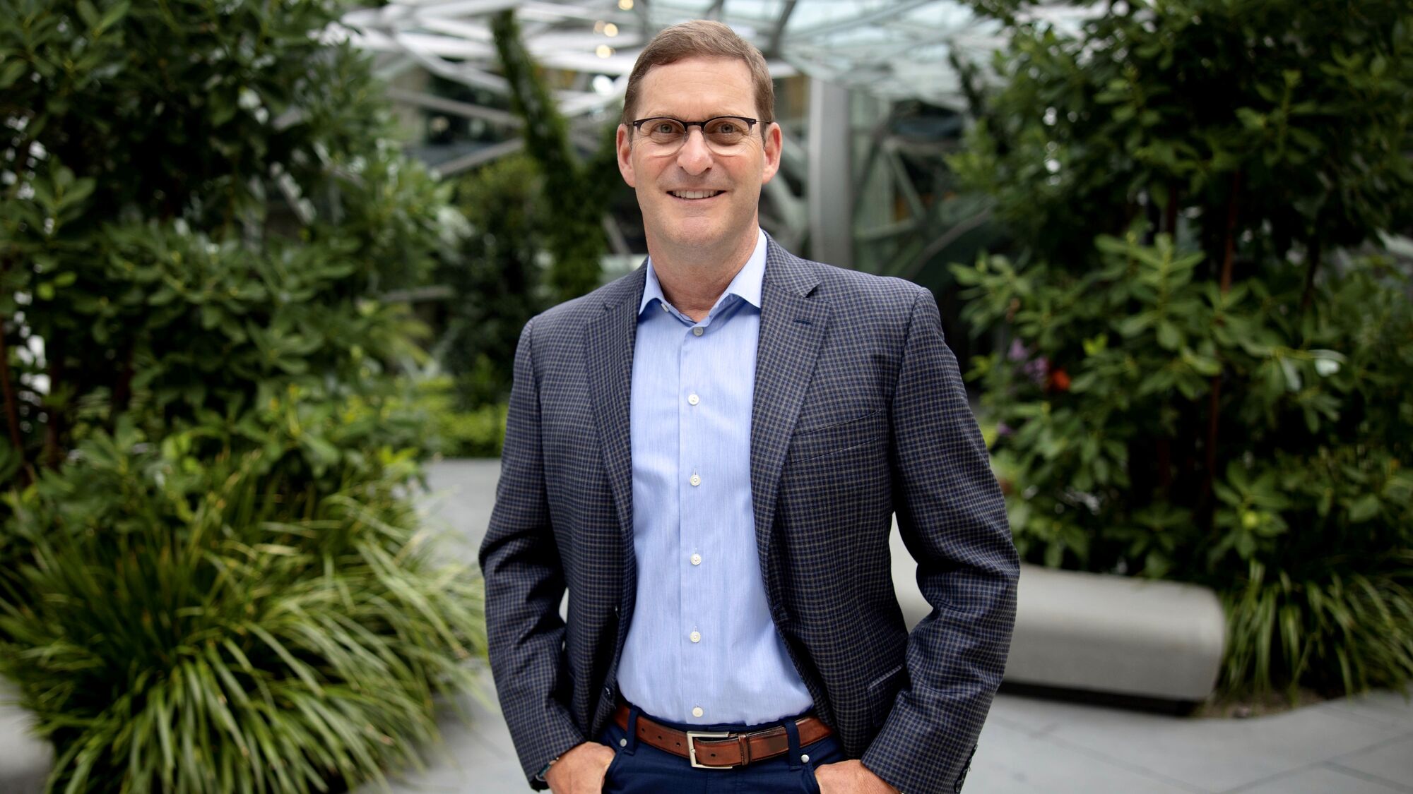 John Schoettler stands outside in front of the Amazon Spheres